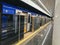 Blue train standing with an open sliding mechanical door at a train station platform. Last stop. Wagons of subway in underground.