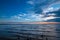 Blue tranquil landscape with lake water and cloudy sky