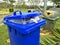 Blue trash cans placed on the street