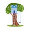 Blue treehouse on big summer tree with ladder, swings and party decorations