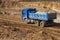 Blue truck and going through gravel ground