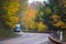 Blue truck on spectacular winding autemn highway