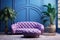 Blue tufted curved sofa, pouf and lounge chair against violet paneling wall and arched window. Art deco style home interior