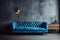 Blue tufted sofa against dark concrete wall with wooden paneling. Loft style interior design