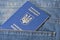 Blue ukrainian passport in pocket of jeans closeup