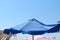 Blue umbrella in a sunny beach day