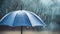 Blue umbrella under rainfall. closeup real drops in natural conditions