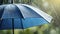 Blue umbrella under rainfall. closeup real drops in natural conditions