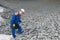 Blue uniformed worker checks the size and quality of the stones