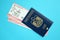 Blue United Arab Emirates passport with airline tickets on blue background close up