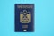 Blue United Arab Emirates passport on blue background close up