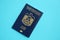 Blue United Arab Emirates passport on blue background close up