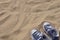 Blue unlaced sneakers on beach