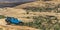 Blue vehicle on a rugged terrain in Moab, Utah