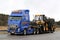 Blue Volvo FH13 Truck Hauls Ponsse Forwarder