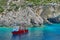 Blue water background. Boat anchored in bay - Ionian Sea, Zakynthos Island, landmark attraction in Greece. Seascape