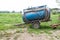 Blue water container trailer to wet soil in roads construction