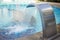 Blue water flowing into the pool. Filling outdoor swimming pool. Blurred background