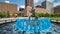 Blue water fountain with Runner Statue at Kiener Plaza Park in St. Louis - ST. LOUIS, USA - JUNE 19, 2019