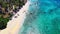 The blue water swashing over at a shoreline of a beach