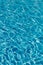 Blue water in swimming pool background. Ripple Water in swimming pool with sun reflection. Blue swimming pool rippled water detail