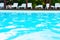 Blue waters in outdoor swimming pool