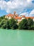 Blue waters of the river with the green trees with beautiful buildings in the background in Fussen