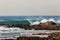 Blue Wave Crashing Rocks Beach