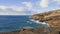 Blue Waves of the Pacific Ocean Beats Oahu Island Volcanic Cliffs. Clear sunny day. Archipelago Hawaii. DCI 4k