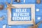 Blue weathered wood with marine or maritime decoration and message Reflex Refresh Recharge in a frame