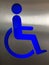 Blue wheelchair accessible sign on a door