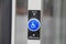 Blue wheelchair button on white pole