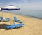 Blue-white beach umbrellas and chaise lounges