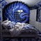 a blue and white bedroom with a large blue and white monster on the wall