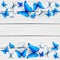 Blue and white butterflies on wooden background