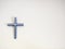 Blue and white catholic cross on a wall