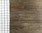 Blue and white checkered dishcloth on brown rustic wooden plank table flat lay top view from above