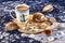 Blue and white cup of coffee, sea shells, compass, blue fishing net on wooden background.