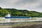 Blue and white freighter container ship traveling along the Seine River from Paris to the English Channel