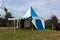 Blue and white medieval tent standing on the hill top with blue sky and white clouds