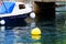 Blue and white motorboat with yellow buoy