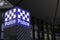 Blue and white \\\'Police\\\' neon sign in front of Spencer Street Police Complex in Melbourne, Australia