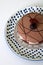 Blue and white polka dot plate with large chocolate dessert on display