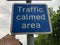 Blue and white rectangular Traffic Calmed area sign