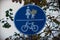 Blue with white road sign - Pedestrian and bicycle crossing. Funny view with leaf over the sign