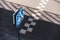 Blue and white sign fixed on pole standing on sidewalk near pedestrian crosswalk