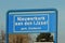 Blue and white sign to mark the start of the urban area in Nieuwerkerk aan den IJssel in the Netherlands.