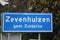 Blue and white sign to mark the start of the urban area in Zevenhuizen in the Netherlands.