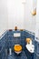 Blue white tiled toilet room with sink