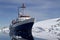 Blue with white tourist ship summer day in Antarctic